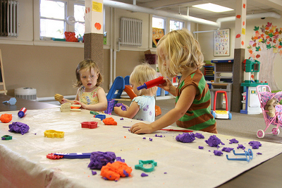 Children playing with playdough. Has nothing to do with the application process other than to entice you.